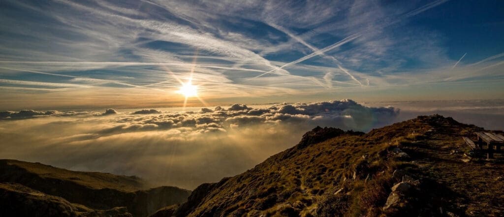 A view of the sun setting over some clouds.