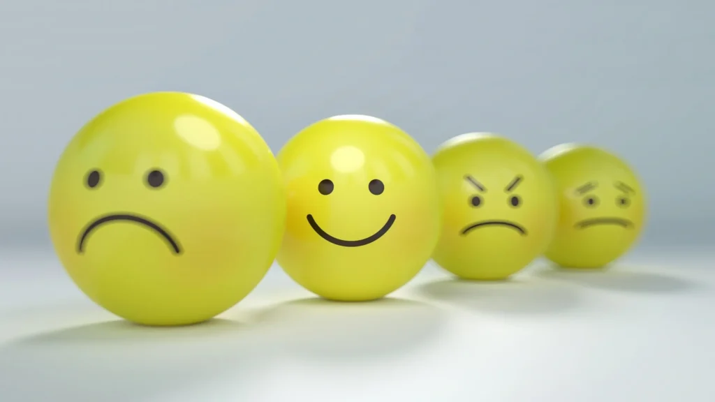 A group of yellow balls with faces drawn on them.