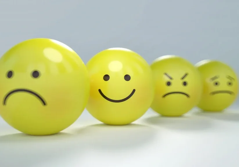 A group of yellow balls with faces drawn on them.